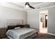 This cozy bedroom features a plush bed, a ceiling fan, and an ensuite bathroom at 136 Positano Trl, Nokomis, FL 34275