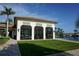 Lounge area beside a lake featuring an entertainment pavilion, and covered seating at 136 Positano Trl, Nokomis, FL 34275