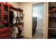 This walk-in closet features custom shelving and a clear line of sight into the laundry room at 136 Positano Trl, Nokomis, FL 34275