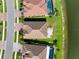 Overhead shot of the home's tile roof, landscaped backyard and the neighborhood waterfront at 13634 Vancanza Dr, Venice, FL 34293