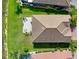 Aerial view of the backyard patio overlooking the pristine lawn extending to the waterfront at 13634 Vancanza Dr, Venice, FL 34293