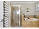 Bright bathroom featuring a walk-in shower and a relaxing soaking tub at 13634 Vancanza Dr, Venice, FL 34293
