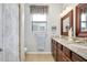 Bright bathroom featuring granite countertops, double sinks, and stylish decor at 13634 Vancanza Dr, Venice, FL 34293