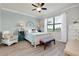 Comfortable bedroom with a large window, serene decor, and neutral-toned walls at 13634 Vancanza Dr, Venice, FL 34293