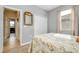 Well-lit bedroom with a comfortable bed, closet, and a charming hallway view at 13634 Vancanza Dr, Venice, FL 34293