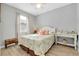 Comfortable bedroom with coastal decor, stylish furnishings, and a window providing natural light at 13634 Vancanza Dr, Venice, FL 34293