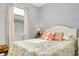 A coastal-themed bedroom boasts a cozy bed, a bright window, and elegant decor at 13634 Vancanza Dr, Venice, FL 34293