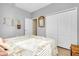 Sunlit bedroom features a closet and beach-themed decor at 13634 Vancanza Dr, Venice, FL 34293