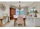 The dining room features a chandelier, a wooden table with seating for six, and neutral decor at 13634 Vancanza Dr, Venice, FL 34293