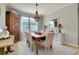 The dining room features a chandelier, a wooden table with seating for six, and neutral decor at 13634 Vancanza Dr, Venice, FL 34293