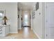 Inviting foyer with neutral paint, tile flooring, elegant lighting fixture, and decorative mirror at 13634 Vancanza Dr, Venice, FL 34293