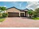 Charming single-Gathering home with a well-manicured lawn, beautiful landscaping and a brick driveway at 13634 Vancanza Dr, Venice, FL 34293