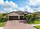 Charming single-Gathering home with a well-manicured lawn, beautiful landscaping and a brick driveway at 13634 Vancanza Dr, Venice, FL 34293