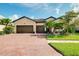 Charming single-Gathering home with a well-manicured lawn, beautiful landscaping and a brick driveway at 13634 Vancanza Dr, Venice, FL 34293