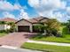 Charming single-Gathering home with a well-manicured lawn, beautiful landscaping and a brick driveway at 13634 Vancanza Dr, Venice, FL 34293