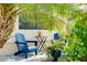 Charming outdoor seating area on the front porch with comfortable blue Adirondack chairs at 13634 Vancanza Dr, Venice, FL 34293