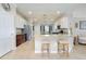 Bright kitchen features an island with bar seating, stainless steel appliances, granite countertops, and pendant lighting at 13634 Vancanza Dr, Venice, FL 34293