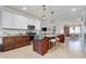 Bright kitchen with granite countertops, stainless appliances, a center island with seating, and pendant lighting at 13634 Vancanza Dr, Venice, FL 34293