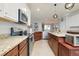 Kitchen featuring granite countertops, stainless steel appliances, custom cabinets and fixtures at 13634 Vancanza Dr, Venice, FL 34293