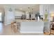 Bright kitchen features an island with bar seating and granite countertops, and stainless steel appliances at 13634 Vancanza Dr, Venice, FL 34293