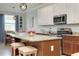 This kitchen showcases granite countertops, an island with seating, and stainless steel appliances at 13634 Vancanza Dr, Venice, FL 34293