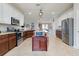 Spacious kitchen features an island, granite countertops, tile flooring, and stainless steel appliances at 13634 Vancanza Dr, Venice, FL 34293