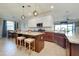 Open concept kitchen boasts a center island, granite countertops, stainless appliances, and pendant lighting at 13634 Vancanza Dr, Venice, FL 34293