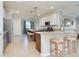 Bright kitchen features two islands with bar seating, stainless steel appliances, granite countertops and tile flooring at 13634 Vancanza Dr, Venice, FL 34293