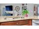 This kitchen island showcases granite countertops, a stainless steel sink, and decorative finishes at 13634 Vancanza Dr, Venice, FL 34293