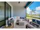 Inviting screened lanai offers comfortable seating and tranquil water views, creating a perfect outdoor retreat at 13634 Vancanza Dr, Venice, FL 34293