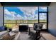 Inviting screened lanai offers comfortable seating and tranquil water views, creating a perfect outdoor retreat at 13634 Vancanza Dr, Venice, FL 34293