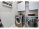 Functional laundry room with stainless steel washer and dryer at 13634 Vancanza Dr, Venice, FL 34293