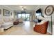 The living room features a sectional sofa, a ceiling fan, and sliding glass doors to the outdoor space at 13634 Vancanza Dr, Venice, FL 34293