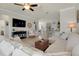 Inviting living room showcasing comfortable seating, tile floors, and an open layout to the kitchen at 13634 Vancanza Dr, Venice, FL 34293