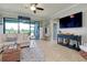 Open-concept living room featuring neutral tones, decorative accents, and sliding glass doors to the lanai at 13634 Vancanza Dr, Venice, FL 34293