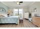 Comfortable main bedroom with a cozy bed, dresser, and ample natural light from the window at 13634 Vancanza Dr, Venice, FL 34293