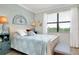Tranquil main bedroom featuring large windows, neutral decor, and an elegant design at 13634 Vancanza Dr, Venice, FL 34293