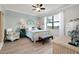 Serene main bedroom with a large window, wood-look floors, and a calming color palette at 13634 Vancanza Dr, Venice, FL 34293