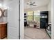 Office space featuring a ceiling fan, desk, and black bookshelves at 13634 Vancanza Dr, Venice, FL 34293