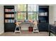 Well-lit office space featuring a large window and built-in bookshelves at 13634 Vancanza Dr, Venice, FL 34293