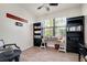 Bright office space with hard floors, a desk, bookshelves, and a seating area at 13634 Vancanza Dr, Venice, FL 34293