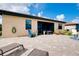 Expansive patio features ample seating, lounge chairs, and a screened lanai under a bright blue sky at 13634 Vancanza Dr, Venice, FL 34293