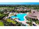 Stunning aerial view of resort-style pool area with palm trees and lounge chairs at 13634 Vancanza Dr, Venice, FL 34293