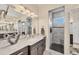 Elegant bathroom featuring dual vanities, marble countertops, designer accents, and a stylish walk-in shower at 14398 Fort Worth Cir, Port Charlotte, FL 33981