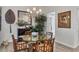 Formal dining area showcasing a glass table with unique wooden base and view of tropical plants at 14398 Fort Worth Cir, Port Charlotte, FL 33981