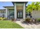 Inviting home entrance with decorative double doors, manicured landscaping, and a charming brick pathway at 14398 Fort Worth Cir, Port Charlotte, FL 33981