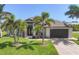 Charming home with well-manicured lawn and palm trees at 14398 Fort Worth Cir, Port Charlotte, FL 33981