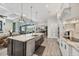 Well-lit kitchen featuring an island with a sink and stainless steel appliances, with an adjacent living space at 14398 Fort Worth Cir, Port Charlotte, FL 33981
