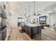 Modern kitchen features stainless steel appliances, large island with seating, and wine fridge at 14398 Fort Worth Cir, Port Charlotte, FL 33981