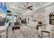 Expansive living room with fireplace that transitions into the kitchen and dining area with sliding glass doors at 14398 Fort Worth Cir, Port Charlotte, FL 33981